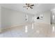 Bright living room featuring tile floors, large windows, and a view into the adjacent kitchen area at 13254 Boulder Woods Cir, Orlando, FL 32824