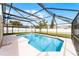 Screened in pool with views of the backyard and fence at 13254 Boulder Woods Cir, Orlando, FL 32824