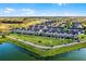 Aerial view of the community shows plentiful greenspace, walking paths, and a pond nearby at 13727 Bressler Aly, Windermere, FL 34786