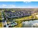 Aerial view of a community with well-maintained homes and lush landscaping, with a nearby pond at 13727 Bressler Aly, Windermere, FL 34786