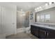 Bright bathroom features a double vanity with granite countertop and glass enclosed shower at 13727 Bressler Aly, Windermere, FL 34786