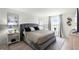 Cozy bedroom features hardwood floors, natural light, and stylish furniture at 13727 Bressler Aly, Windermere, FL 34786