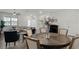Open-concept living space with hardwood floors, seamlessly connecting the dining, living, and kitchen areas at 13727 Bressler Aly, Windermere, FL 34786