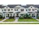 Charming two-story townhome featuring a well-manicured lawn and inviting front porch at 13727 Bressler Aly, Windermere, FL 34786