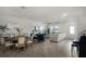 Open-concept living space with hardwood floors, seamlessly connecting the living, dining, and kitchen areas at 13727 Bressler Aly, Windermere, FL 34786