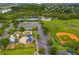 Aerial view of a community featuring a playground, parking, tennis courts, and baseball field at 14225 Southern Red Maple Dr, Orlando, FL 32828