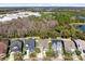 Aerial view showing the community layout near a wooded area, business park and a body of water at 14225 Southern Red Maple Dr, Orlando, FL 32828