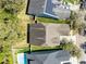 An aerial view of a residential neighborhood with well-maintained lawns and solar panels on one of the rooftops at 14225 Southern Red Maple Dr, Orlando, FL 32828