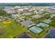 Aerial view of community featuring clubhouse, playgrounds, tennis courts, and a baseball field at 14225 Southern Red Maple Dr, Orlando, FL 32828
