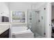 Bright bathroom features a soaking tub next to a glass enclosed shower at 14225 Southern Red Maple Dr, Orlando, FL 32828