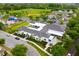 Aerial view of a clubhouse with a large parking lot and sports fields nearby at 14225 Southern Red Maple Dr, Orlando, FL 32828