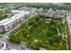 An aerial view of a vibrant community park with green spaces, trees, and recreational facilities at 14225 Southern Red Maple Dr, Orlando, FL 32828
