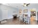 Open concept dining room featuring wood floors, natural light, and seamless access to other rooms at 14225 Southern Red Maple Dr, Orlando, FL 32828