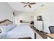 A spacious main bedroom with a ceiling fan and wood floors featuring a view of the backyard at 14225 Southern Red Maple Dr, Orlando, FL 32828