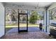 Screened in patio with brick pavers and a view of the backyard at 14225 Southern Red Maple Dr, Orlando, FL 32828