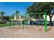 Community swings with a bright green frame and residential homes in the background at 14225 Southern Red Maple Dr, Orlando, FL 32828