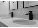 Close-up of a dual sink bathroom vanity with quartz countertop and waterfall faucets at 16659 Sw 21St Avenue Rd, Ocala, FL 34473