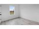 Bright bedroom with light gray flooring, a large window, and white walls at 16659 Sw 21St Avenue Rd, Ocala, FL 34473
