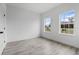 Bedroom featuring gray flooring and two large windows at 16659 Sw 21St Avenue Rd, Ocala, FL 34473