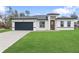 Charming single-story home featuring a well-manicured lawn and a two-car garage, perfect for suburban living at 16659 Sw 21St Avenue Rd, Ocala, FL 34473