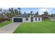 Charming single-story home featuring a well-manicured lawn and a two-car garage, perfect for suburban living at 16659 Sw 21St Avenue Rd, Ocala, FL 34473