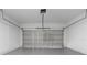 Spacious garage with gray epoxy flooring and a modern sectional door, ready for vehicles and storage at 16659 Sw 21St Avenue Rd, Ocala, FL 34473