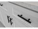 Close up detail of kitchen cabinetry with black hardware against a white finish at 16659 Sw 21St Avenue Rd, Ocala, FL 34473