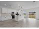 Bright, modern kitchen featuring white cabinets, quartz countertops, stainless steel appliances, and a functional island at 16659 Sw 21St Avenue Rd, Ocala, FL 34473