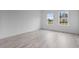 Bright living room with gray flooring and natural light from exterior view windows at 16659 Sw 21St Avenue Rd, Ocala, FL 34473