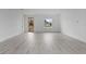 Bright living room with gray floors, a wooden front door, and a window with an exterior view at 16659 Sw 21St Avenue Rd, Ocala, FL 34473