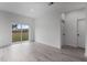 White living room featuring gray floors, white walls, sliding glass door, and white trim and doors at 16659 Sw 21St Avenue Rd, Ocala, FL 34473