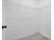 Walk-in closet featuring wire shelving and gray wood look flooring at 16659 Sw 21St Avenue Rd, Ocala, FL 34473