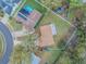 An aerial view shows a residence that features solar panels and a pool, all within a fenced perimeter at 1730 Country Terrace Ln, Apopka, FL 32703