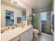 Bright bathroom with neutral colors, a vanity, a large mirror, a toilet, and a shower with textured tile at 1730 Country Terrace Ln, Apopka, FL 32703