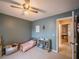 Neutral toned bedroom with a single bed, ceiling fan and toy shelf for convenient organization at 1730 Country Terrace Ln, Apopka, FL 32703