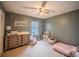Cozy bedroom with green walls, a ceiling fan, a window for natural light, and charming decor at 1730 Country Terrace Ln, Apopka, FL 32703