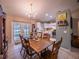 Inviting dining room features a chandelier, a table with seating for six, and natural light from the doors to the backyard at 1730 Country Terrace Ln, Apopka, FL 32703