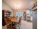 Inviting dining room features a chandelier, a table with seating for six, and natural light from the doors to the backyard at 1730 Country Terrace Ln, Apopka, FL 32703