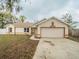 Single-story home with a two-car garage and manicured lawn, showcasing its curb appeal at 1730 Country Terrace Ln, Apopka, FL 32703