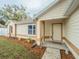 Inviting front entrance with a well-maintained lawn, walkway, and charming details at 1730 Country Terrace Ln, Apopka, FL 32703