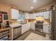 Efficient kitchen with white cabinets, stainless steel appliances, a double sink, and a breakfast nook with lots of natural light at 1730 Country Terrace Ln, Apopka, FL 32703