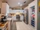 Bright kitchen with white cabinets, stainless steel appliances, including a refrigerator, and a walk-in pantry for ample storage at 1730 Country Terrace Ln, Apopka, FL 32703