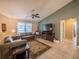 Bright living room features tile floors, neutral colored walls, and a ceiling fan at 1730 Country Terrace Ln, Apopka, FL 32703