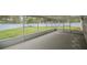 Enclosed patio with screen panels overlooks the spacious backyard enclosed by a white fence at 1730 Country Terrace Ln, Apopka, FL 32703
