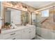 Bathroom features tiled shower/tub, updated vanity and large mirror at 178 W Sabal Palm Pl # 178, Longwood, FL 32779