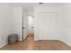 Bedroom with wood floors, a large closet, and access to another room at 178 W Sabal Palm Pl # 178, Longwood, FL 32779
