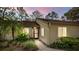 Inviting one-story home featuring a lush landscaped front yard and a cozy, welcoming entrance at 178 W Sabal Palm Pl # 178, Longwood, FL 32779