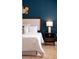 Stylish main bedroom with dark blue accent wall and matching night stand at 178 W Sabal Palm Pl # 178, Longwood, FL 32779
