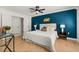 Main bedroom with modern furnishings, fan, and dark accent wall at 178 W Sabal Palm Pl # 178, Longwood, FL 32779