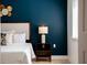 Stylish main bedroom with dark blue accent wall and matching night stand at 178 W Sabal Palm Pl # 178, Longwood, FL 32779